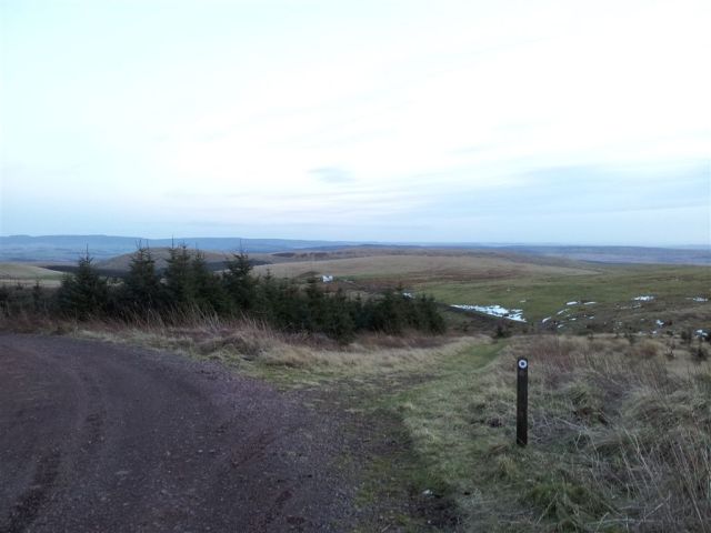 Clennel St heads right then across the fields round the bump distant left Clennel St heads right then across the fields round the bump distant left